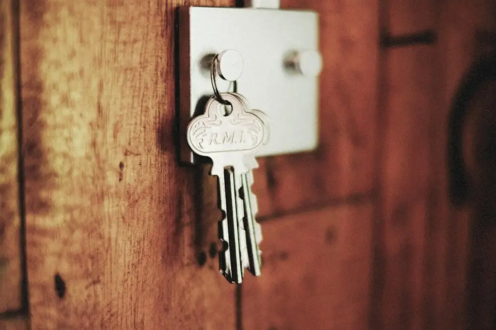 house keys hanging on a wall hook in wooden interior
