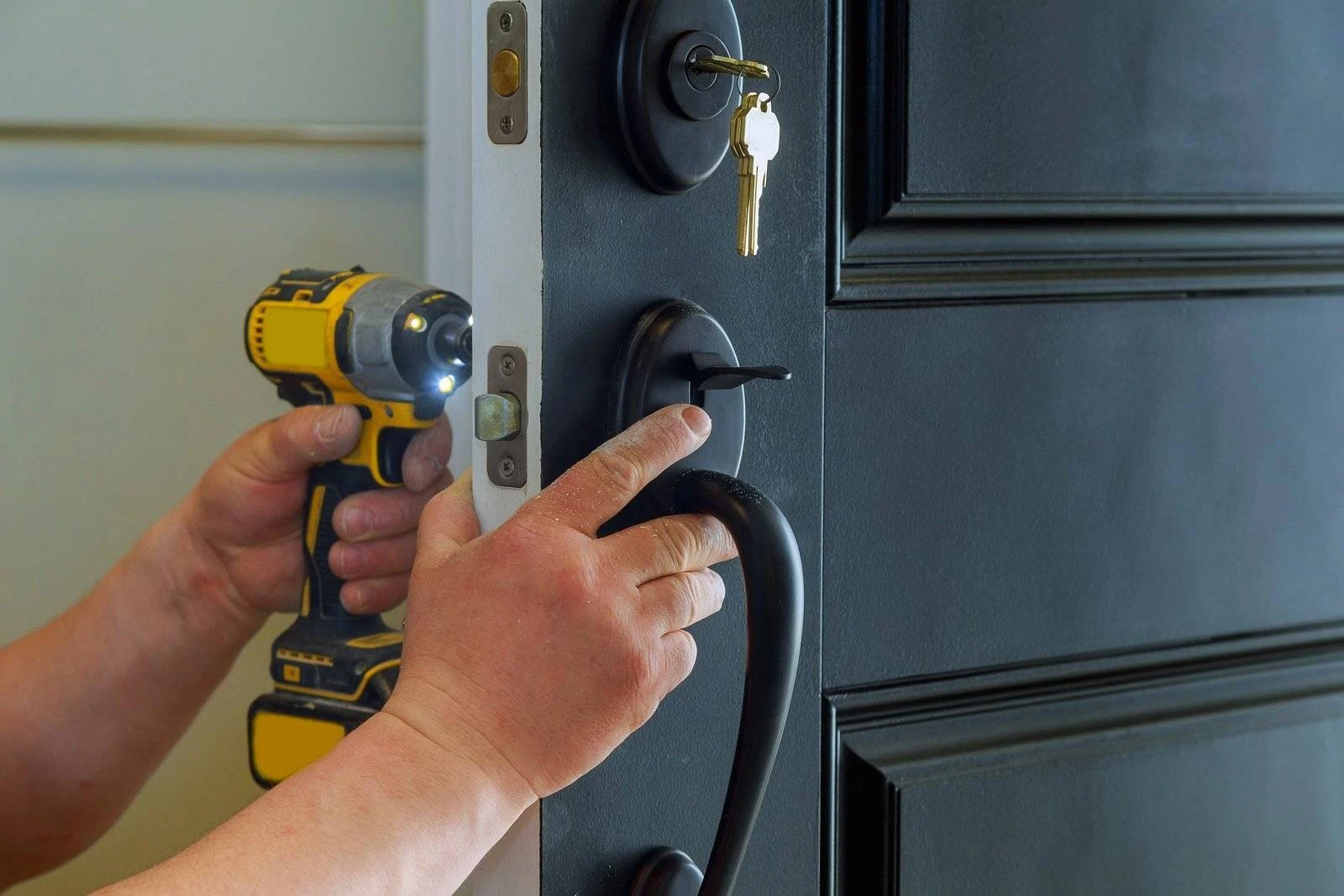 DGM locksmith fitting a new lock on a front door in Birmingham
