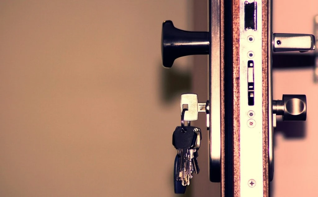 Keys inserted in a door lock showing home security and access control