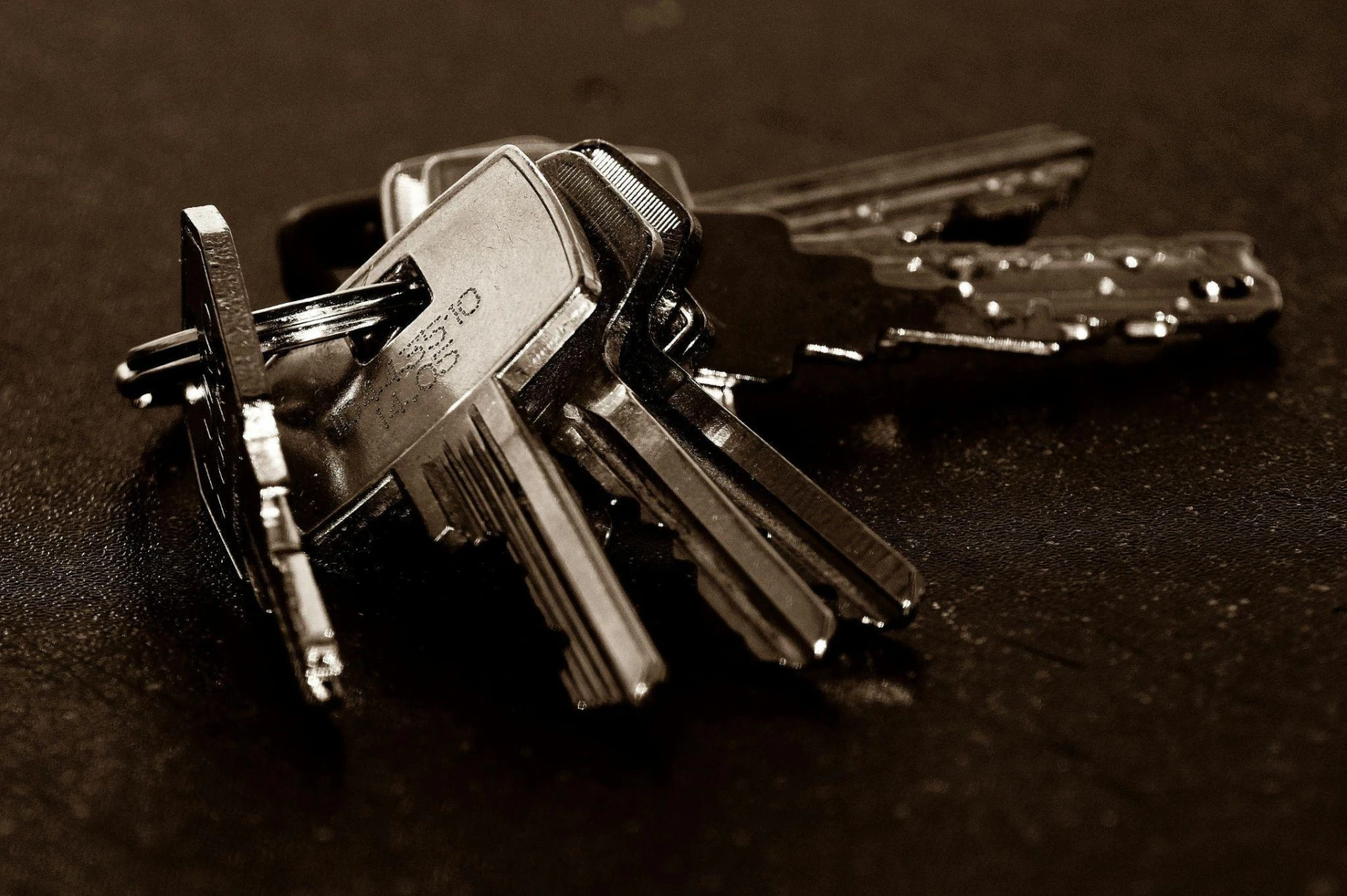 Set of silver keys on a dark surface
