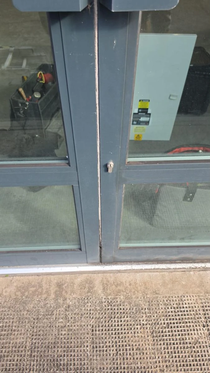 Aluminium shop door lock before replacement by DGM Locksmiths Birmingham